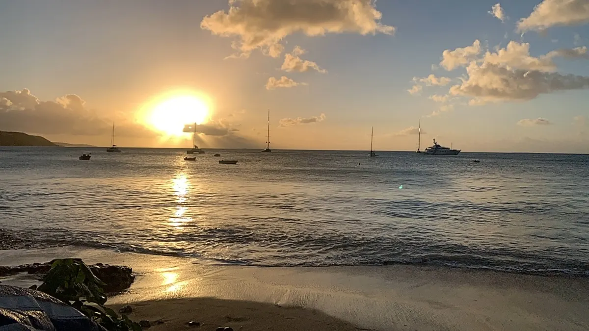 Golden sunset over boats anchored in Crocus Bay
